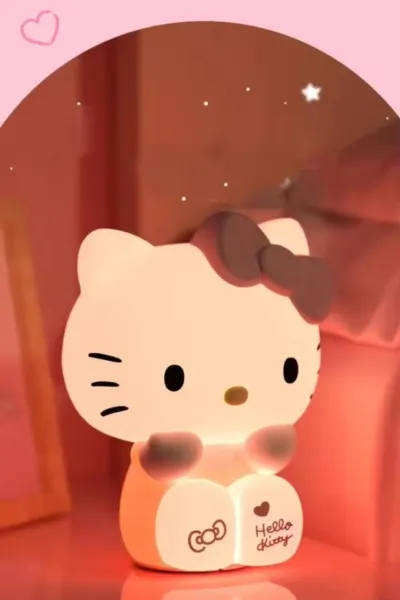 Warm yellow glow from the Hello Kitty Silicone Night Lamp on a dark bedside table.