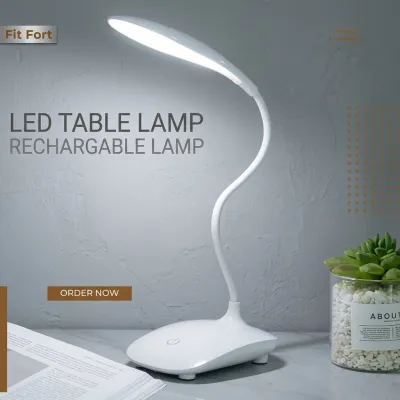 White rechargeable study lamp price in Pakistan on a desk next to books and a potted plant.
